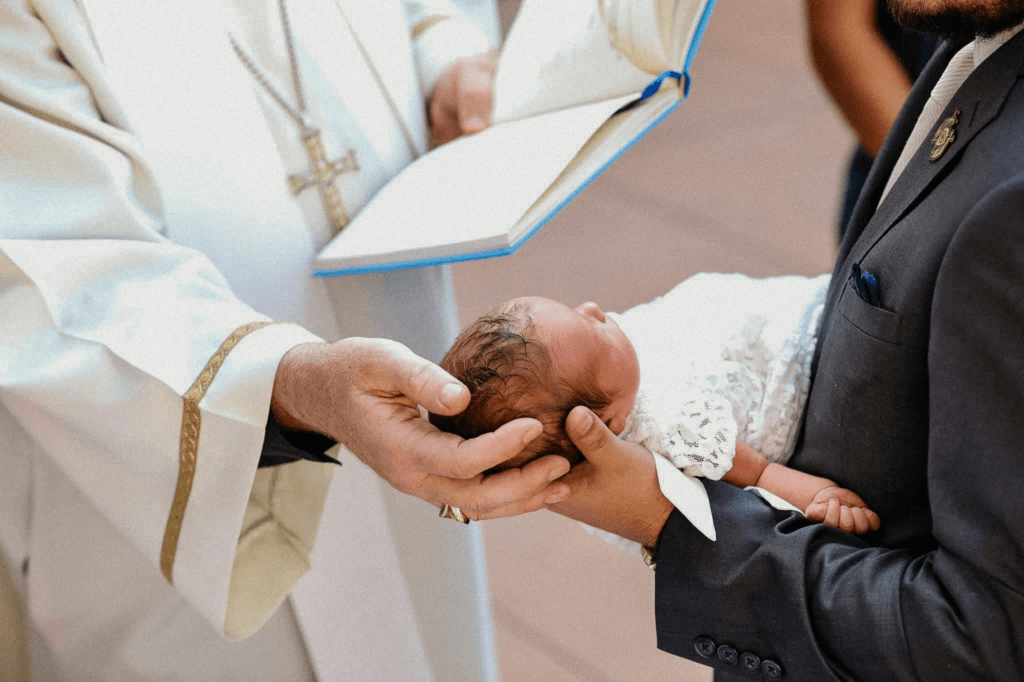 A baby baptism ceremony with a pastor 640x480