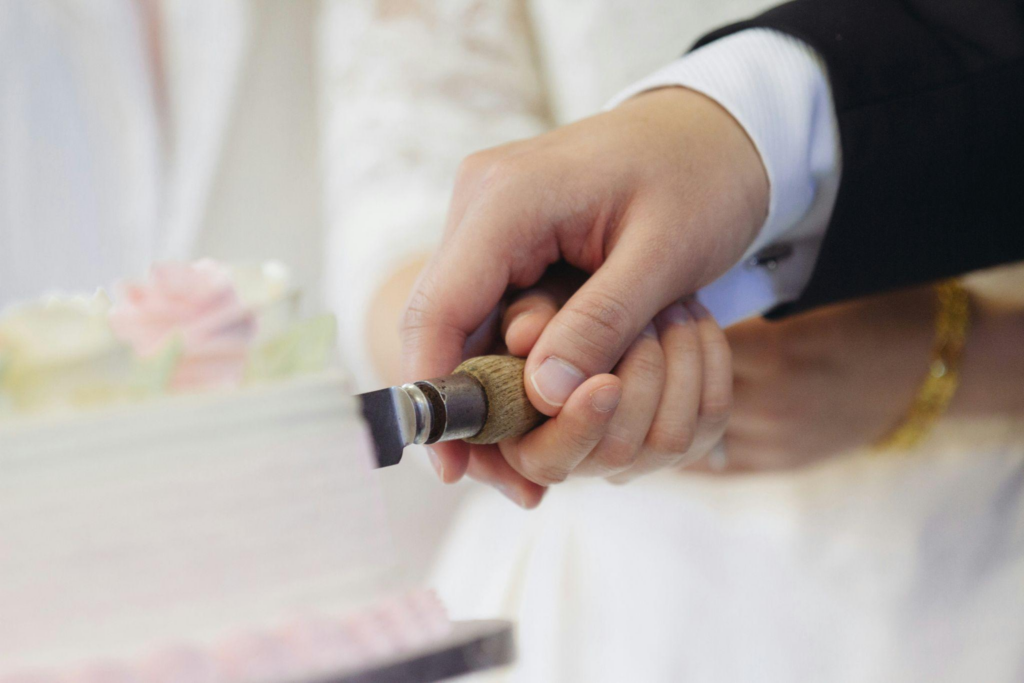 A joyful wedding cake cutting moment