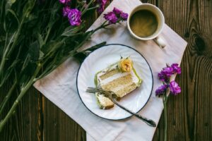 A cup of tea and a piece of cake are on the table