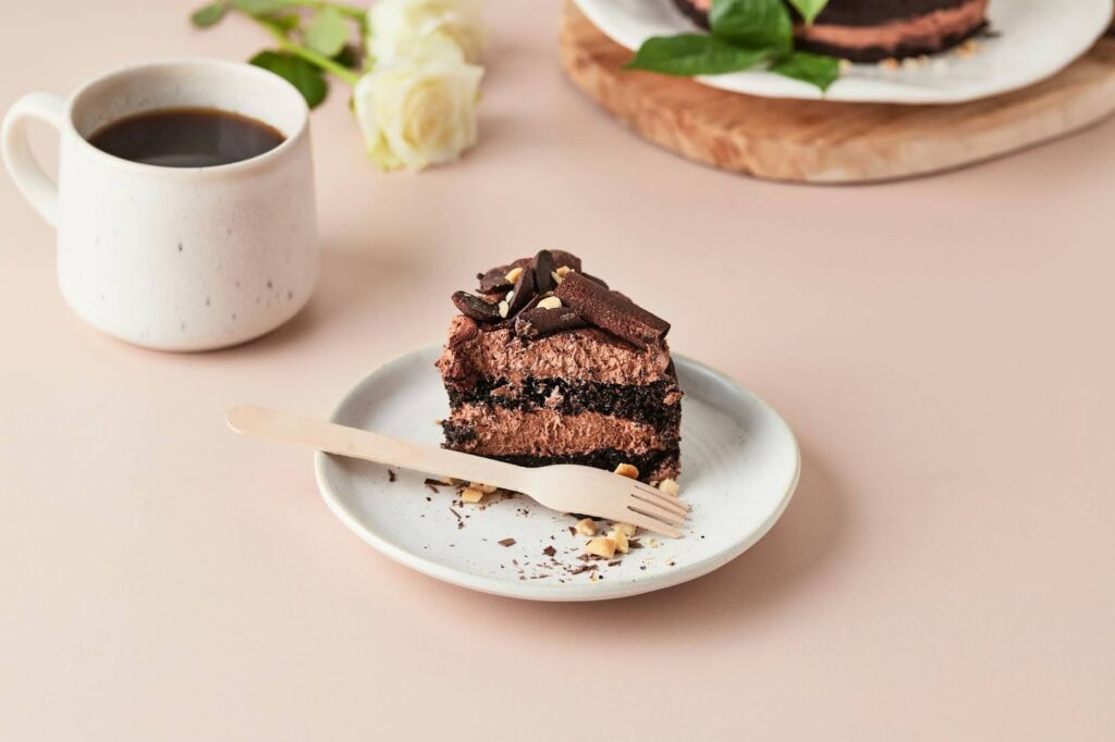 A piece of chocolate cake on a plate with a fork